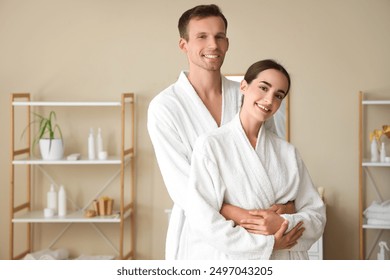 Young couple hugging after shower in bathroom - Powered by Shutterstock