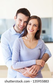 Young Couple Hugging At Home