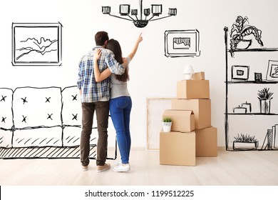 Young couple imagining interior of new house. Moving day