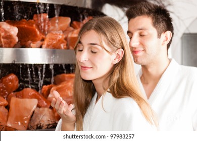 Young couple inhaling essential oil in salt cave of a Spa