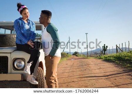 Young couple interacting with each other at countryside