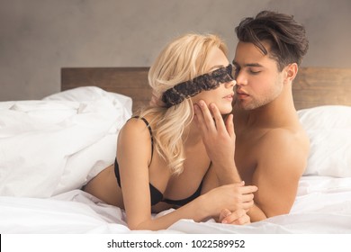 Young couple intimate relationship on bed passion