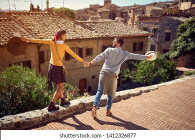 Young Couple At The Italy - Happy Tourists Couple Visiting Toscana.
