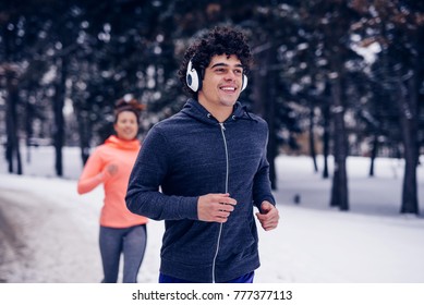 Young Couple Jogging On A Winter Day