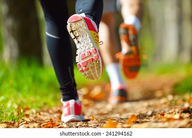 Young Couple Jogging In Park At Morning. Health And Fitness.