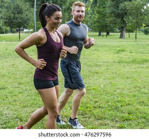 Young Couple Jogging In Park At Morning