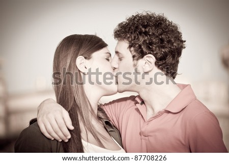 Similar – Young couple kissing in a studio portrait