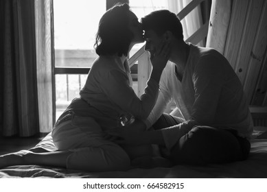 Young Couple Kissing  In Bed.Black And White Photo 