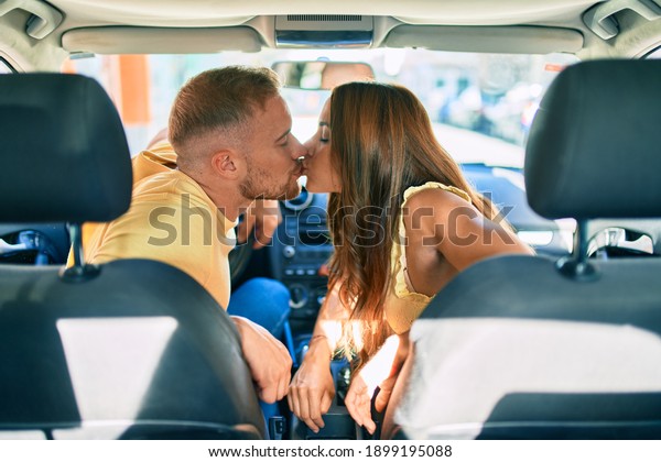 Young couple kissing at the\
car,