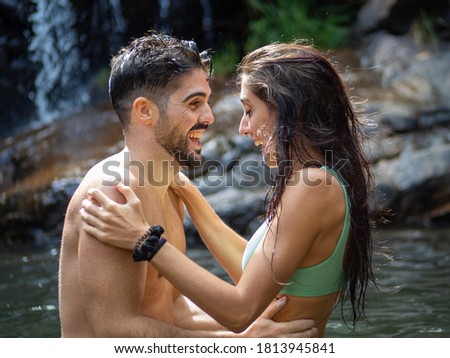 young couple kissing and hugging in a lake in Bali