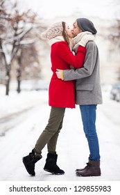 Young Couple Kissing On Winter Day