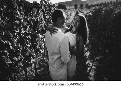 Young Couple Kissing In A Vineyard.