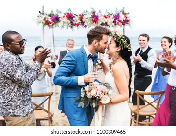 Young couple kissing at wedding reception