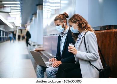 Young Couple With A Laptop On The Subway Platform .