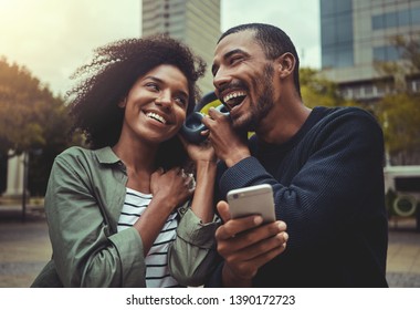 Young Couple Listening Music On One Headphone