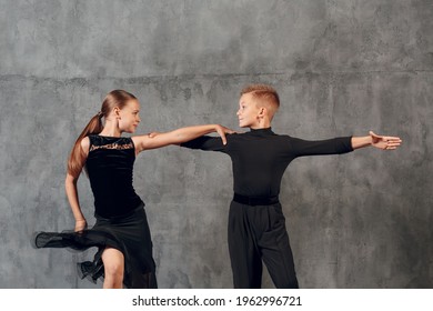 Young Couple Little Boy And Girl Dancing In Ballroom Dance Jive.