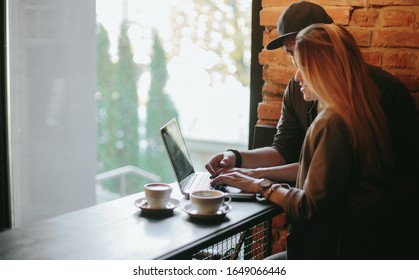 Young Couple In Loft Cafe