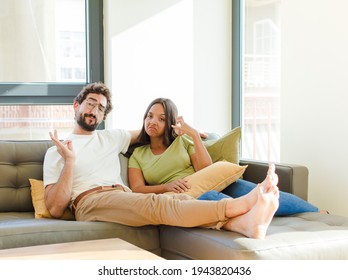 Young Couple Looking Arrogant, Successful, Positive And Proud, Pointing To Self. New Home Concept