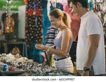 Young couple are looking at a jewellery stall in Queen Victoria Market, Australia.