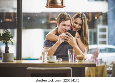 Young Couple Looking Tablet