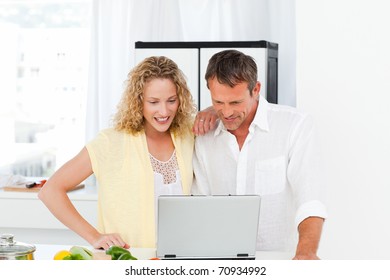Young couple looking at their laptop at home
