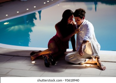 Young couple in love by the pool