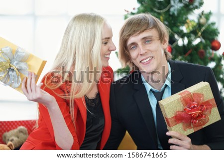 Young couple in love celebrates christmas in the house, Merry Christmas.