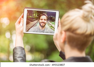 young couple in love chatting over a video call, by using a tablet. graded with a flare - Shutterstock ID 495523807