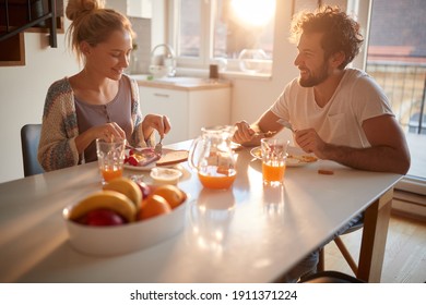 A young couple in love enjoying in breakfast at home together on a beautiful morning. Relationship, love, together, breakfast - Powered by Shutterstock