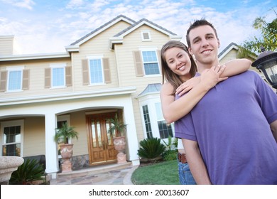 A young couple in love in front of their new home