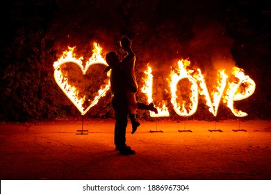 Young Couple In Love Have Fun Near Burning Fire Letters Love And Heart