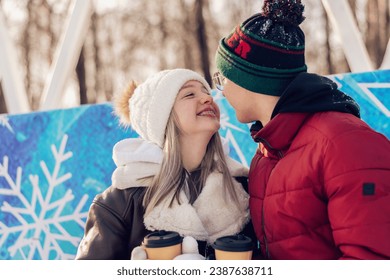 Young couple in love have fun, active date ice skating on the ice arena on a winter day.Laughing teenagers relax on a bench,drink hot cocoa,talk.Winter entertainment,leisure activity,Valentine's day. - Powered by Shutterstock