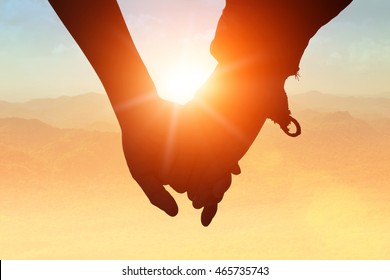 Young couple in love couple holding hands while walking in autumn being. Union hands strong have experience used to help support people each other to survive african with happy integrating concept. - Powered by Shutterstock