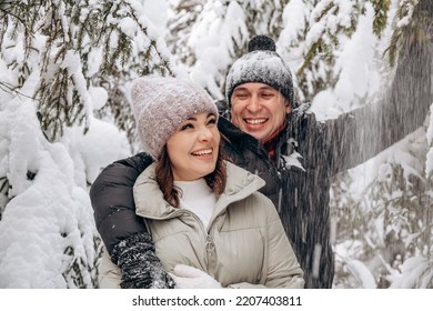 Young couple in love hugging in the winter forest and having fun spending time together.Winter,Valentine's day,newlyweds, tenderness and love. - Powered by Shutterstock