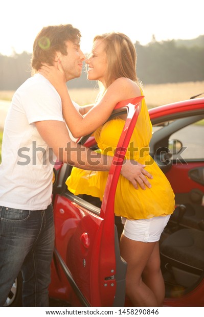 Young couple in love\
kissing in a car