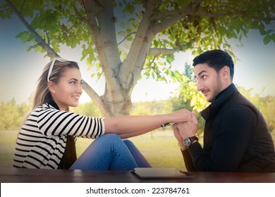 Young Couple In Love Looking In Each Others Eyes - Romantic Happy Couple Feeling Flirty And Holding Hands 