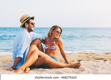 Young couple in love lying on the beach, enjoying
