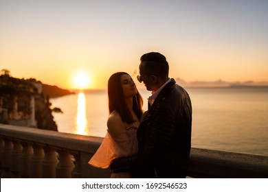 Young Couple In Love Near Italian Beach On Sunset 