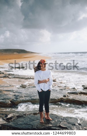 Young couple in love on the beach.Beautiful couple in white.Lovers holding hands and hugging