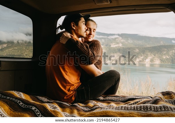 Young couple in\
love on road trip in \
Canada