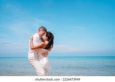 Young couple in love outdoor. Happy man Hugging and laughing to his woman romantic at tropical beach. Girlfriend with boyfriend resting travel at sunrise in summer. - Powered by Shutterstock