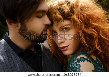 Similar – Young couple in love are posing face to face