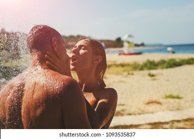 Young couple in love outdoor. Stunning sensual outdoor portrait of young stylish fashion couple posing in summer in field. Happy Smiling Couple in love. They are smiling and looking at each other. Sex