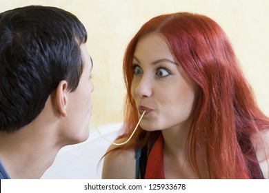 Young Couple In Love Sharing Spaghetti