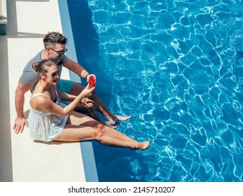 Young couple in love sitting by the pool on the empty deck of a cruise liner. Closeup, outdoor, view from above. Vacation and travel concept - Powered by Shutterstock