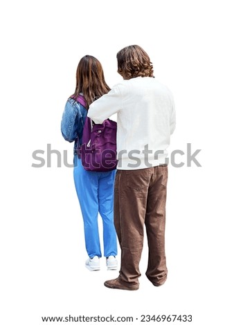 A young couple in love standing in the street wearing brightly colored, casual clothes. The young man looks in the girl's backpack and searches for something. Back view of cut out isolated people