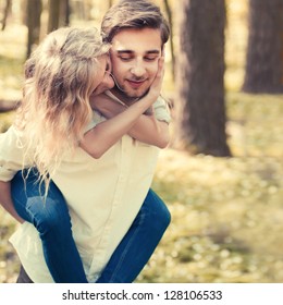 A Young Couple In Love Walking In The Woods