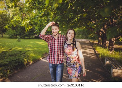 A Young Couple In Love Walking In The Woods