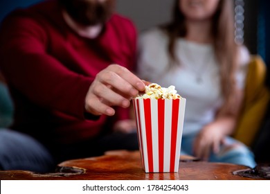 A Young Couple In Love Watching Television At Night Romantic Date Night Lying On The Couch Eating Popcorn Happy Dating