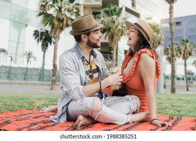 Young Couple Of Lovers Drinking Cocktails Doing Picnic At City Park During Coronavirus Outbreak - Focus On Faces